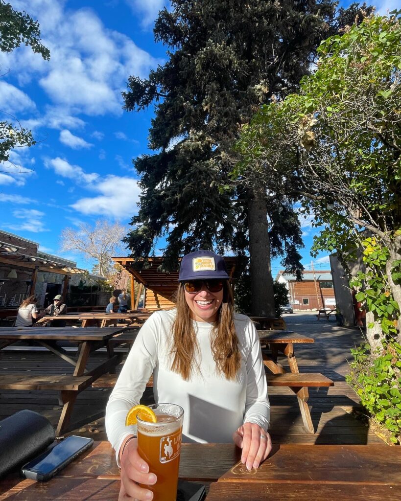 Lander Bar patio in Lander, Wyoming with a babe holding a freshly poured local beer
